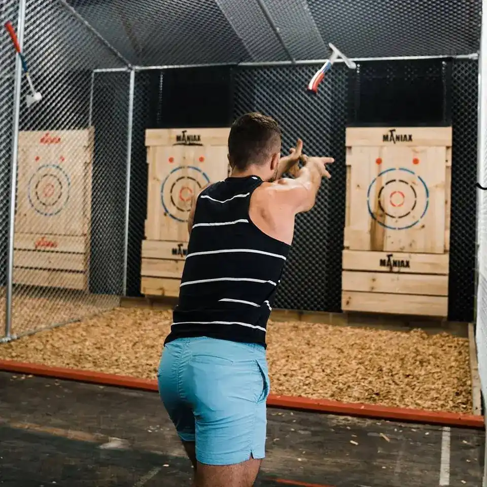 Guest throwing an axe at wooden targets