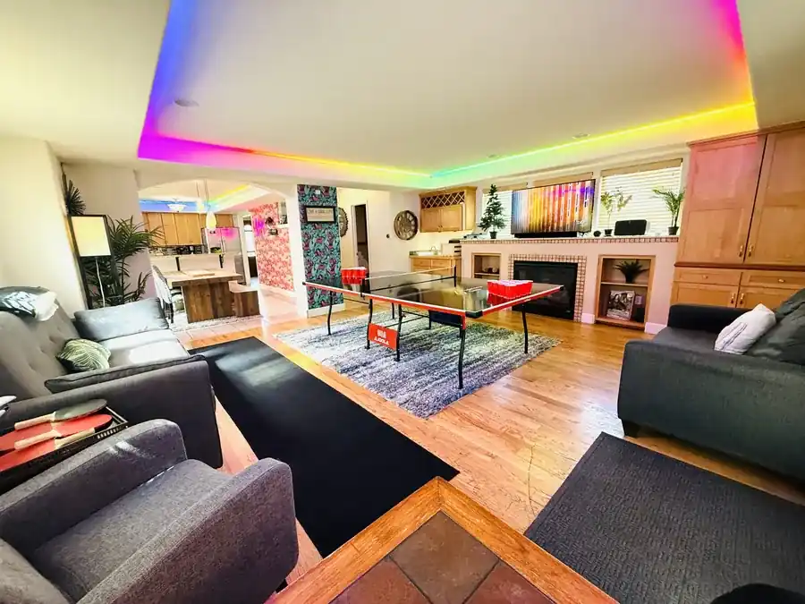 RiNo Party Palace living room with beer pong table and rainbow lighting
