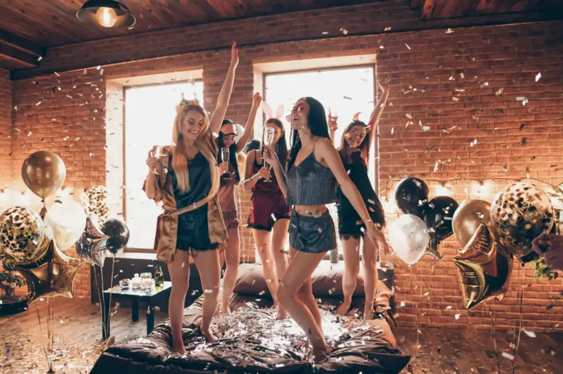 Group dancing with balloons and confetti